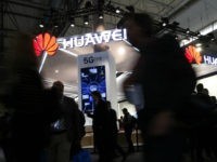 People walk by the Huawei stand at the Mobile World Congress (MWC), the world's biggest mobile fair, on February 26, 2018 in Barcelona. The Mobile World Congress is held in Barcelona from February 26 to March 1. / AFP PHOTO / Pau Barrena (Photo credit should read PAU BARRENA/AFP/Getty Images)