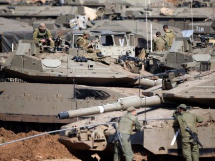 Israeli soldiers work on their tanks at a gathering area near the Israel-Gaza border, in southern Israel, Tuesday, March 26, 2019. Israeli Prime Minister Benjamin Netanyahu returned home from Washington on Tuesday, heading straight into military consultations after a night of heavy fire as Israeli aircraft bombed Gaza targets and …