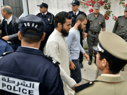 A picture taken on May 2, 2019 shows suspects, in the murder of two Scandinavian hikers, arriving for their trial at a Moroccan court in Sale near the capital Rabat. - A Moroccan court adjourned for two weeks the trial of two dozen suspects accused of the murder of two …