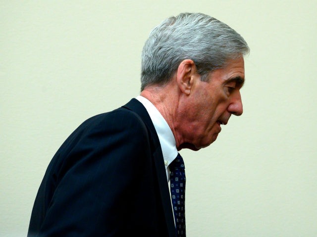 Former Special Counsel Robert Mueller leaves for a break as he testifies during a House Se