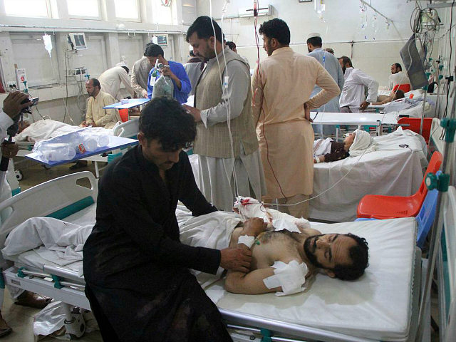 A wounded man receives treatment in a hospital after a suicide attack on the outskirts of