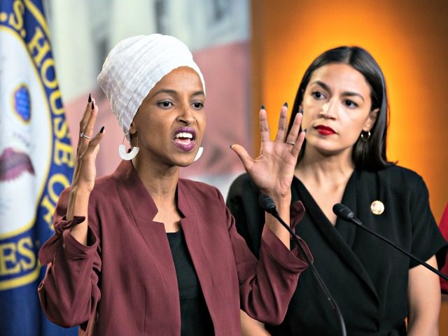 U.S. Rep. Ilhan Omar, D-Minn., left, joined at right by U.S. Rep. Alexandria Ocasio-Cortez, D-N.Y., responds to base remarks by President Donald Trump after he called for four Democratic congresswomen of color to go back to their "broken" countries, as he exploited the nation's glaring racial divisions once again for …