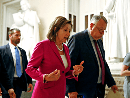 House Speaker Nancy Pelosi of Calif., left, walks out of the House Chamber, Tuesday, July 16, 2019, on Capitol Hill in Washington. (AP Photo/Patrick Semansky)