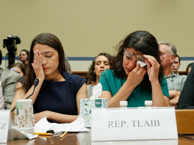 Rep. Rashida Tlaib, D-Mich., center, wipes her eyes after testifying before the House Oversight Committee hearing on family separation and detention centers, Friday, July 12, 2019 on Capitol Hill in Washington. Sitting at the panel with Tlaib are Rep. Alexandria Ocasio-Cortez, D-NY., left, and Rep. Ayanna Pressley, D-Mass., right. (AP …