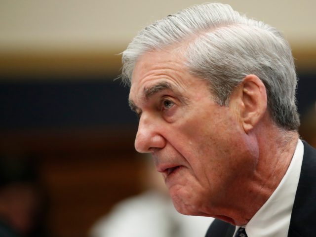 Former special counsel Robert Mueller, accompanied by his top aide in the investigation Aa