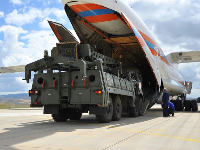 Military vehicles and equipment, parts of the S-400 air defense systems, are unloaded from