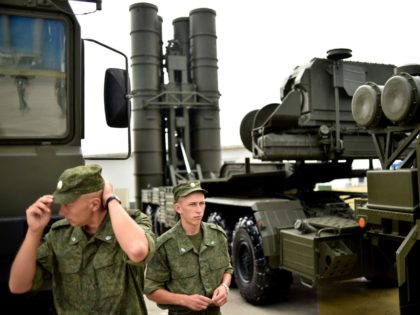 Russia's soldiers stand guard near Russia's air defence system S-400 Triumf launch vehicle