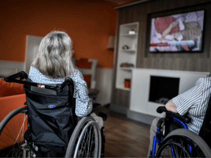 Elderlies residents sit on wheelchairs watch the television on July 5, 2018, in an establishment of accommodation for dependent elderly (EHPAD) in Paris. (Photo by STEPHANE DE SAKUTIN / AFP) (Photo credit should read STEPHANE DE SAKUTIN/AFP/Getty Images)
