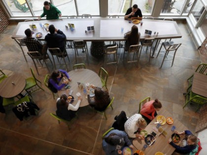 Students at the University of New Hampshire have lunch at the new $17,000 custom-made chef's table, top, at the campus dining hall Friday April 29, 2016 in Durham, N.H. The University of New Hampshire now acknowledges that spending $17,000 on a custom-made chef's table with LED lights for the campus …