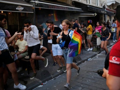 People run to avoid the effects of tear ga , fired by police to disperse activists on a street in central Istanbul, after a Pride march event was banned by authorities, in Istanbul, Sunday, June 30, 2019. Activists gathered in Istanbul to promote rights for gay and transgender people Sunday …
