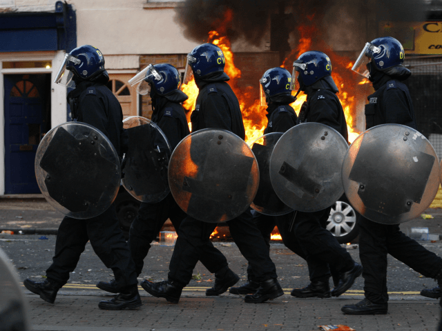 LONDON, ENGLAND - AUGUST 08: Riot police walk along Clarence Road in Hackney on August 8, 2011 in London, England. Pockets of rioting and looting continues to take place in various boroughs of London this evening, as well as in Birmingham, prompted by the initial rioting in Tottenham and then …