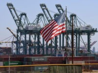 The US flag flies over Chinese shipping containers that were unloaded at the Port of Long Beach, in Los Angeles County, on September 29, 2018. - President Donald Trump insisted that there had been "absolutely no impact" on the US economy from the escalating trade dispute between his administration and …
