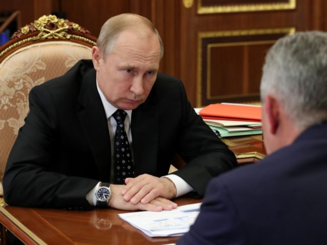 Russian President Vladimir Putin (L) and Defence Minister Sergei Shoigu hold a meeting on