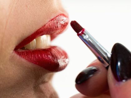 Woman applying lipstick