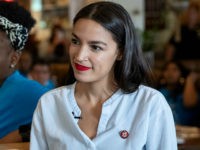 NEW YORK, NY - MAY 31: U.S. Rep. Alexandria Ocasio-Cortez (D-NY) stands with supporters of the One Fair Wage campaign before waiting tables and bartending at the Queensboro Restaurant, May 31, 2019 in the Queens borough of New York City. Ocasio-Cortez participated in an event to raise awareness for the …