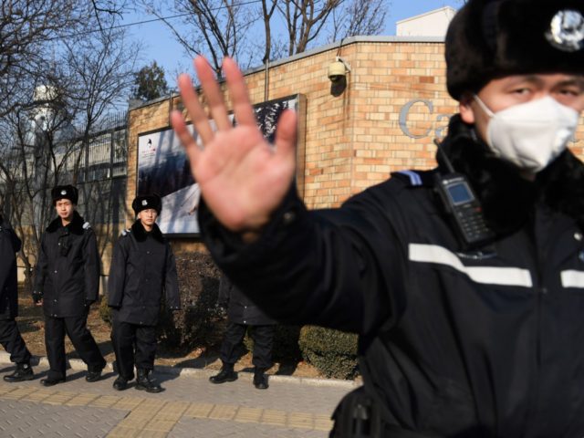 Chinese police patrol in front of the Canadian embassy in Beijing on December 14, 2018. -