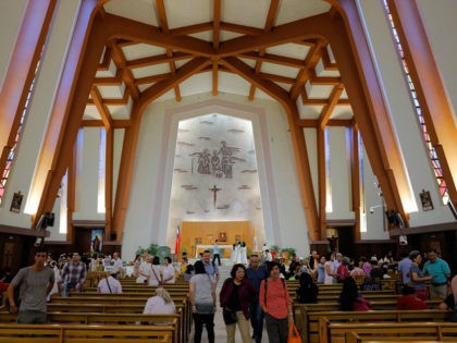Worshippers leave after a service at the Holy Family Church in Taipei on September 23, 201
