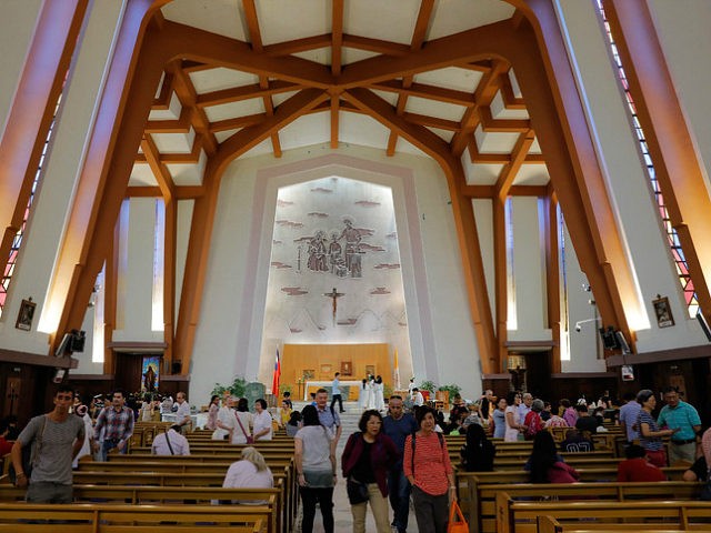 Worshippers leave after a service at the Holy Family Church in Taipei on September 23, 2018. - Worshippers at masses in Hong Kong and Taiwan on September 23 were largely upbeat about a new deal between China and the Vatican despite fears Beijing is trying to up control of the …