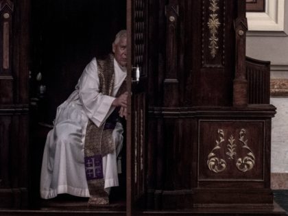 A priest hears a confession at the Metropolitan Cathedral in San Jose, Costa Rica on June 02, 2019. - Costa Rican deputy Enrique Sanchez, of the ruling Accion Ciudadana party, proposes a bill that would allow to raise the secret of priestly confession in investigations about child abuse. (Photo by …