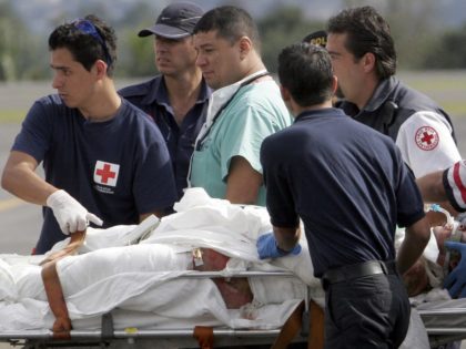 Costa Rican Red Cross workers attend to one of the burn victims from a chemical plant fire, as he arrives by air ambulance at the Juan Santamaria International Airport near Alajuela , Costa Rica, Wednesday, Dec. 13, 2006. Three people were killed and three people were transported by air ambulance …