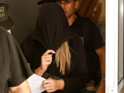 This picture taken on July 30, 2019 shows a British teenager who accused seven Israelis of gang rape leaving the Famagusta District Court in Paralimni in eastern Cyprus. - Initially, the 19-year-old woman had alleged that 12 Israelis gang raped her at the hotel where she was staying in the …