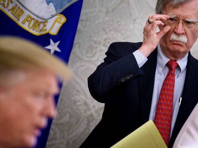 National Security Advisor John R. Bolton listens while US President Donald Trump speaks to the press before a meeting with Hungary's Prime Minister Viktor Orban in the Oval Office of the White House on May 13, 2019, in Washington, DC. (Photo by Brendan Smialowski / AFP) (Photo credit should read …