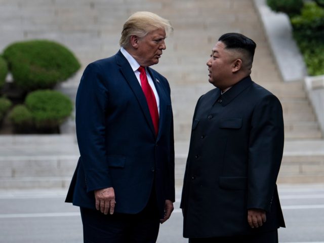 TOPSHOT - US President Donald Trump and North Korea's leader Kim Jong-un stand on North Ko