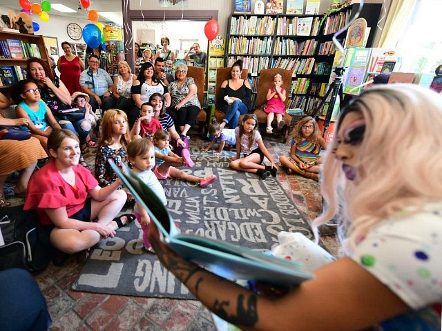 Drag queen Scalene Onixxx reads to adults and children during Drag Queen Story Hour at Cellar Door Books in Riverside, California on June 22, 2019. - Athena and Scalene, their long blonde hair flowing down to their sequined leotards and rainbow dresses, are reading to around 15 children at a …