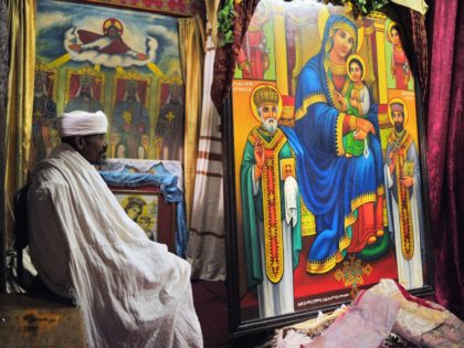 An Ethiopian Orthodox Christian priest sits inside a church in Lalibela on January 18, 201