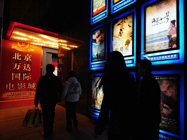 Moviegoers make their way to a multiplex cinema in Beijing on February 14, 2009, where Tai