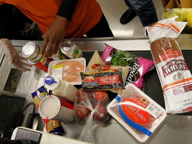 In this April 23, 2012, file photo Philadelphia Mayor Michael Nutter's purchases are scanned by a cashier at a ShopRite grocery story in Philadelphia after Nutter pledged to live on the average food stamp benefit of five dollars a day for the entire week. Food stamps look ripe for the …