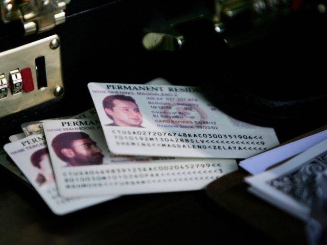 Alexandria, UNITED STATES: Permanent residence cards, known as green cards, rest on the check-in table as resident aliens arrive for a naturalization ceremony at George Washington's Mount Vernon in Alexandria, VA, 22 May 2006. Ninety-five people took the oath of US citizenship at the historic location, home to the first …