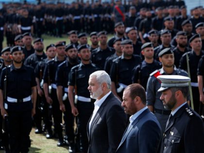 Gaza's Hamas Prime Minister Ismail Haniyeh, center, and Fathi Hamad, Gaza's Hamas interior minister, second right, review honor guards during a graduation ceremony of Hamas security officers in the northern Gaza Strip, Wednesday, April 2, 2014. 1200 officers graduated from advanced training courses that lasted one year in Gaza police …