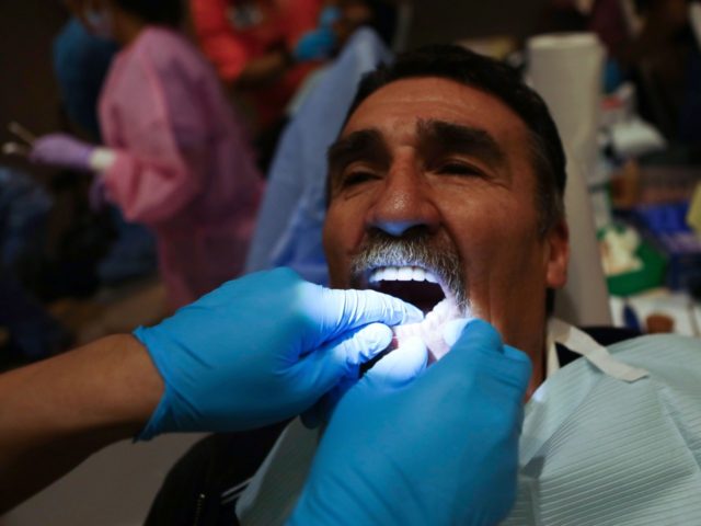MODESTO, CA - OCTOBER 27: Patient William Tucker is fitted with dentures at a free dental clinic put on by volunteers with the California Dental Association Foundation on October 27, 2018 in Modesto, California. The two-day clinic is expected to provide free treatment to about 1,900 people who lack access …