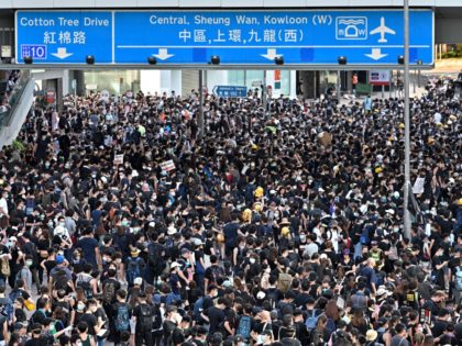 TOPSHOT - Protesters gather on roads outside the government headquarters in Hong Kong on J