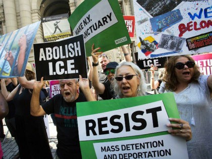 Protesters hold up signs and chant slogans outside a cybersecurity summit, Tuesday, July 31, 2018, in New York. The protesters are opposed to the recent separation of children and parents who are detained by Immigration and Customs Enforcement (ICE). (AP Photo/Mark Lennihan)