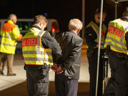 PASSAU, GERMANY - SEPTEMBER 03: Members of the Bavarian police (Landespolizei) arrest a man on the suspicion of smuggling migrants from Austria into Germany in the early hours on the A3 highway on September 3, 2015 near Passau, Germany. The A3 and nearby smaller roads are a favorite conduit for …