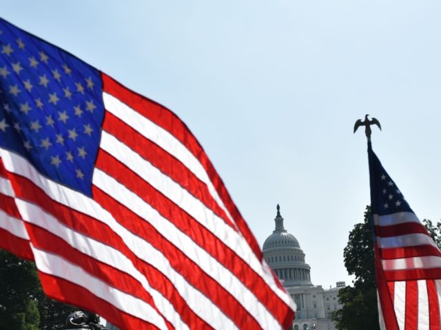 US flags are seen near the Mall in front of the US Capitol in Washington, DC on July 3, 20