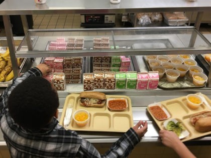 FILE - In this Jan. 25, 2017, file photo, students fill their lunch trays at J.F.K Element