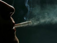 LONDON - MAY 16: In this photo illustration a man smokes a cigarette on May 16, 2007 in London. Businesses and shops are gearing up for the introduction of the smoking ban on July 1 in England after similar bans have been introduced in Ireland, Scotland and Wales. (Photo Illustration …