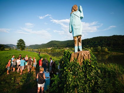 People gather around what conceptual artist Ales ‘Maxi’ Zupevc claims is the first ever monument of Melania Trump, set in the fields near the town of Sevnica, US First Ladys hometown, during a small inauguration celebration on July 5, 2019. (JURE MAKOVEC/AFP/Getty Images)