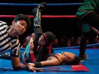 This picture taken on July 6, 2019 shows the hijab-wearing Malaysian wrestler known as Nor "Phoenix" Diana (C) wrestling with a male opponent during a match organised by Malaysia Pro Wrestling in Kuala Lumpur. - A hijab-wearing, diminutive Malaysian wrestler known as "Phoenix" cuts an unusual figure in the ring, …