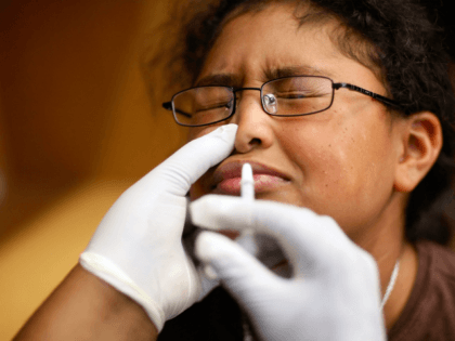MIAMI - OCTOBER 19: Daniela Diaz,11, receives a H1N1 nasal flu spray vaccine from nurse Sh