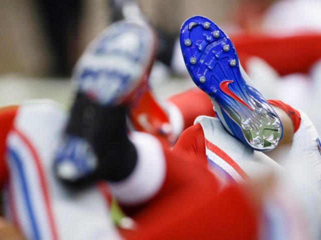 Detail of Nike shoes as New York Giants players stretch before an NFL football game agains