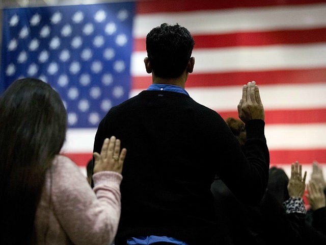 FILE - In this Feb. 15, 2017 file photo, people take the oath of citizenship during a naturalization ceremony at the Los Angeles Convention Center. In a Los Angeles ceremony Wednesday, Sept. 20, 2017, more than 9,000 new American citizens will hear a newly recorded message from President Donald Trump …