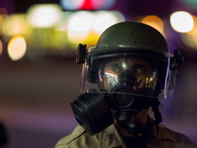 EL CAJON, CA - SEPTEMBER 29: A San Diego County Sheriffs deputy wear a gas mask as an unla