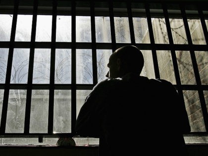 NORWICH, UNITED KINGDOM - AUGUST 25: (EDITORS NOTE: IMAGES EMBARGOED FOR PUBLICATION UNTIL 0001GMT AUGUST 26, 2005) 19 year old inmate James looks out of the window of the Young Offenders Institution attached to Norwich Prison on August 25, 2005 in Norwich, England. A Chief Inspector of Prisons report on …