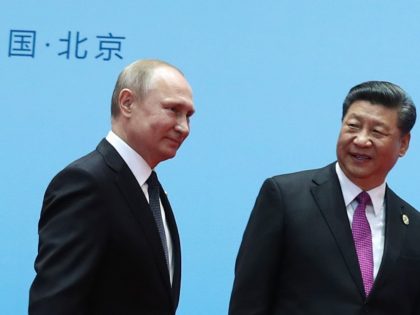 TOPSHOT - China's President Xi Jinping (R) and Russia's President Vladimir Putin smile during the welcoming ceremony on the final day of the Belt and Road Forum in Beijing on April 27, 2019. - Chinese President Xi Jinping urged dozens of world leaders on April 27 to reject protectionism and …