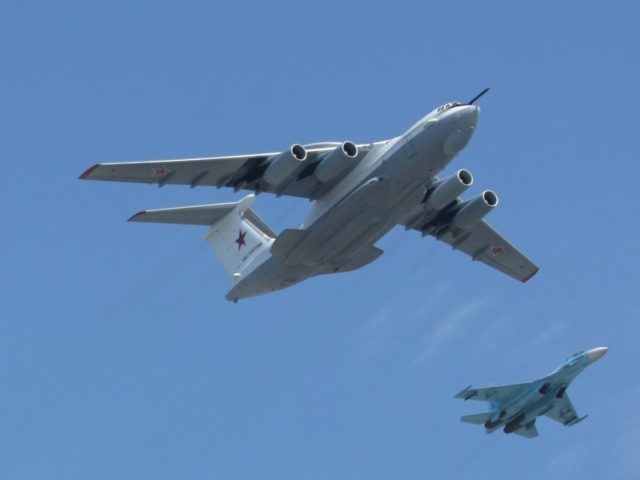 A Russian A-50 plane and Su-27 fighter jets fly over St. Basil's cathedral during the Vict