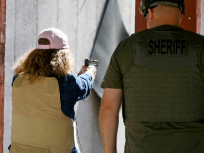 In this Saturday, June 29, 2019, photo, Cindy Bullock, Timpanogos Academy secretary, participates in shooting drills at the Utah County Sheriff's Office shooting range during the teacher's academy training, in Spanish Fork Canyon, Utah. About 30 teachers in Utah are spending their summer learning how to stuff wounds and shoot …